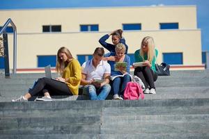 students outside sitting on steps photo