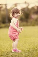 little girl spending time at backyard photo