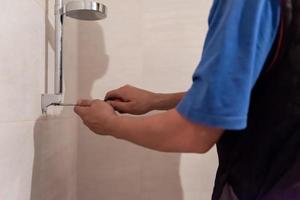 professional plumber working in a bathroom photo