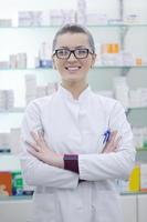 pharmacist chemist woman standing in pharmacy drugstore photo