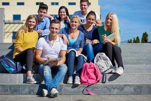 students outside sitting on steps photo