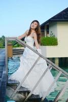 asian bride on beach photo