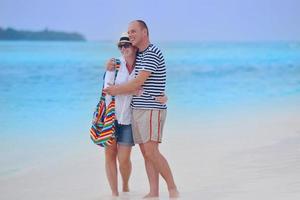 happy young couple have fun on beach photo