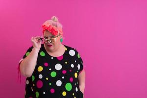 Happy Plus Size Woman Wearing Eyeglasses Smiling To Camera Standing Over Pink Background. Cheerful Millennial Female In Eyewear Posing In Studio. photo