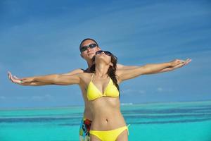 happy young  couple enjoying summer on beach photo