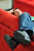 man relaxing on sofa photo