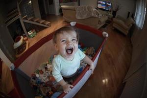 cute  little  baby playing in mobile  bed photo