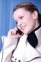 a beautiful  business woman on the phone at work photo