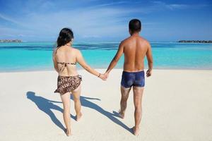 happy young  couple enjoying summer on beach photo