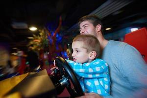 father and son playing game in playground photo