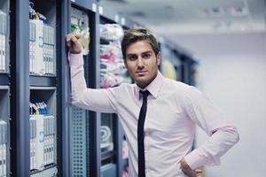 young it engeneer in datacenter server room photo