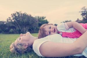 mother and little daughter playing at backyard photo