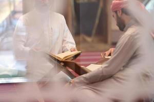 muslim people in mosque reading quran together photo