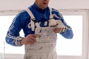 construction worker plastering on gypsum walls photo