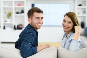 a young married couple enjoys sitting in the large living room photo