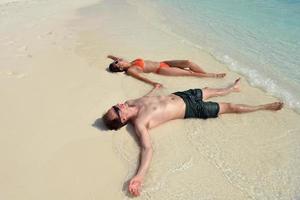 happy young couple have fun on beach photo