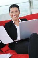 young business woman working on laptop at home photo