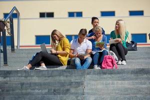 students outside sitting on steps photo