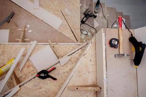 work in progress on stylish interior with wooden stairs photo