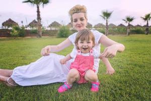 mother and little daughter playing at backyard photo