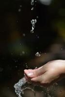 water stream on woman hand photo