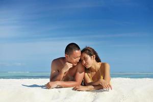 happy young  couple enjoying summer on beach photo