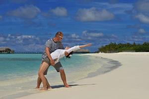 happy young couple have fun on beach photo