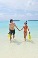 happy young couple have fun on beach photo