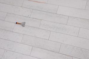 Ceramic wood effect tiles and tools for tiler on the floor photo