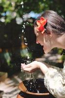 splashing fresh water on woman hands photo