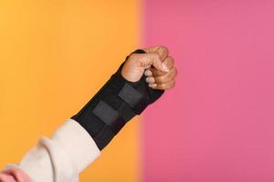 hand injury. a female injured hand on a yellow background photo