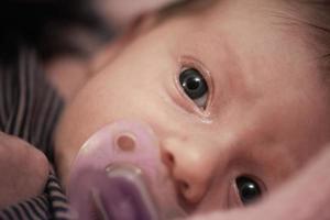 One month newborn baby sleeping  in bed photo