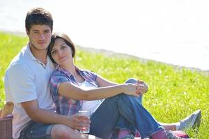 happy young couple having a picnic outdoor photo