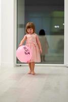 cute little girl playing with balloons photo