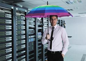 businessman hold umbrella in server room photo