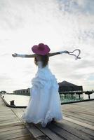 asian bride on beach photo