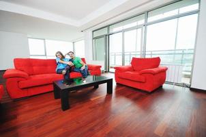 happy couple relax on red sofa photo