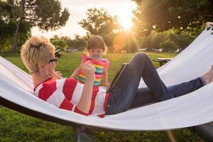 mom and a little daughter relaxing in a hammock photo