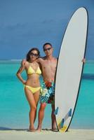 happy young  couple enjoying summer on beach photo