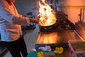 Chef doing flambe on food photo