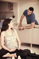 pregnant couple checking a list of things for their unborn baby photo