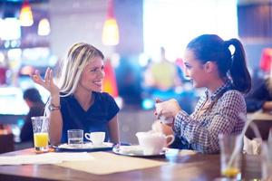 girls have cup of coffee in restaurant photo