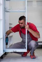 worker installing a new kitchen photo