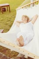 young woman resting on hammock photo