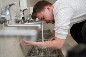 A Muslim takes ablution for prayer. Islamic religious rite photo