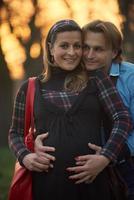 young pregnant couple have fun and relax photo