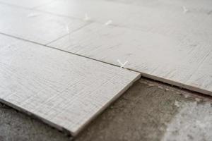 Ceramic wood effect tiles and tools for tiler on the floor photo