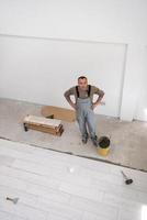 worker installing the ceramic wood effect tiles on the floor