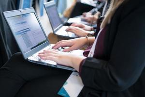 close up of business people hands using laptop computer photo