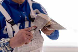 construction worker plastering on gypsum walls photo